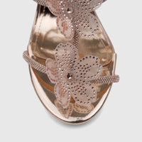 Rose gold high heel sandal with shimmering rhinestone flower embellishments and metallic finish, viewed from above.