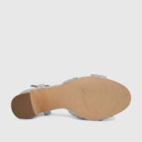 Bottom view of a silver Bulbul Ladies Evening Block Heel Sandal with sparkling rhinestone straps and a light brown sole.