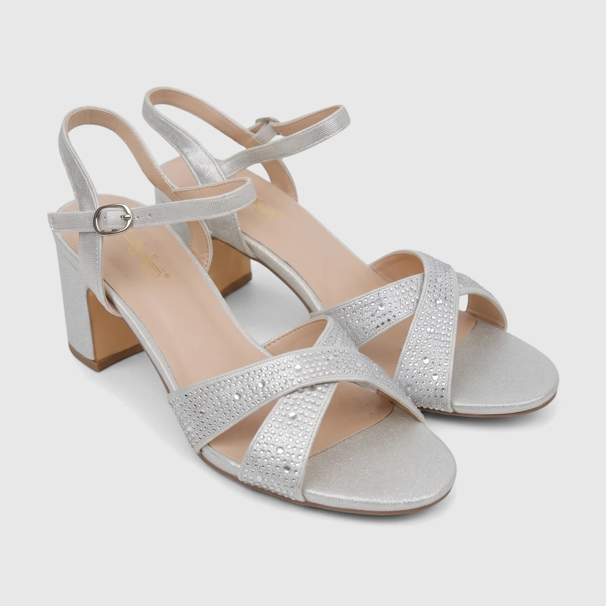 Pair of Bulbul Ladies Evening Block Heel Sandals in silver glitter with rhinestone-studded cross straps, ideal for formal