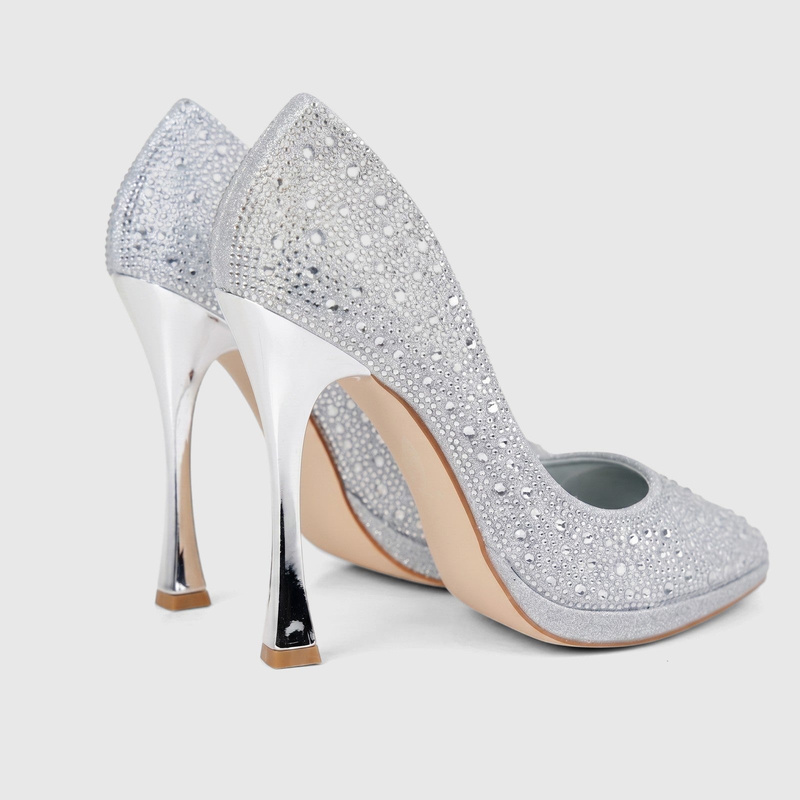 A pair of elegant Bulbul Ladies Evening Court Shoes LU026 in silver, embellished with sparkling rhinestones, on a white