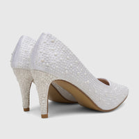 Pair of white pearl-embellished high-heeled court shoes on a light background, viewed from the back.
