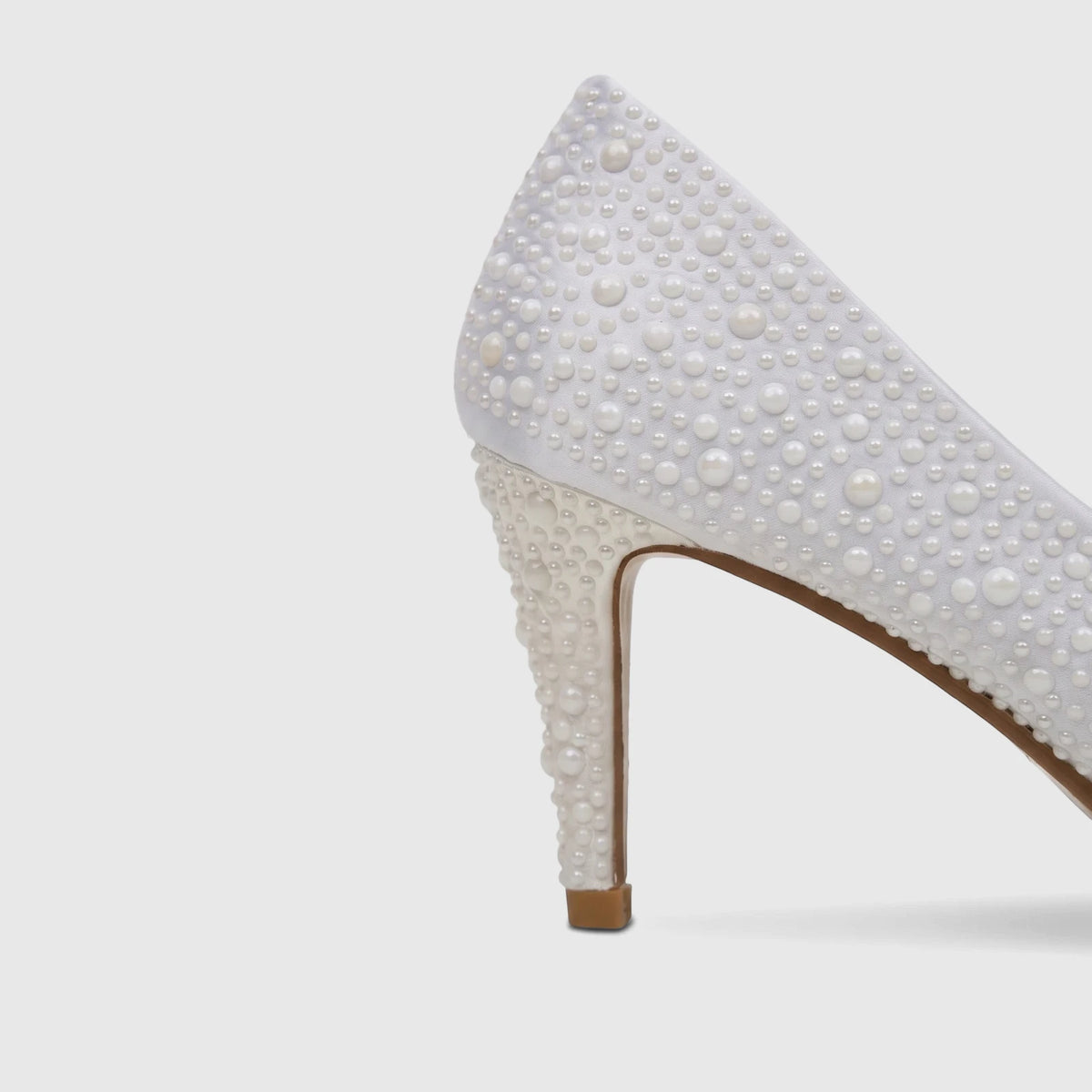 Elegant white pearl-embellished high-heeled court shoe, perfect for evening wear or bridal occasions.