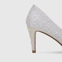Elegant white pearl-embellished high-heeled court shoe, perfect for evening wear or bridal occasions.
