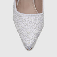 Close-up of a white satin ladies' evening court shoe with a pointed toe, heavily embellished with various sizes of pearls.