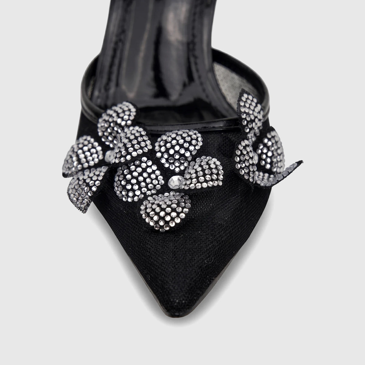 Black ladies' evening heel sandal with pointed toe and sparkling crystal floral embellishments, shown close-up.