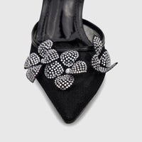 Black ladies' evening heel sandal with pointed toe and sparkling crystal floral embellishments, shown close-up.