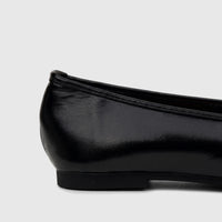 Side profile of a Bulbul Ladies Evening Pump in black patent leather, showcasing the glossy finish and low heel of the flat