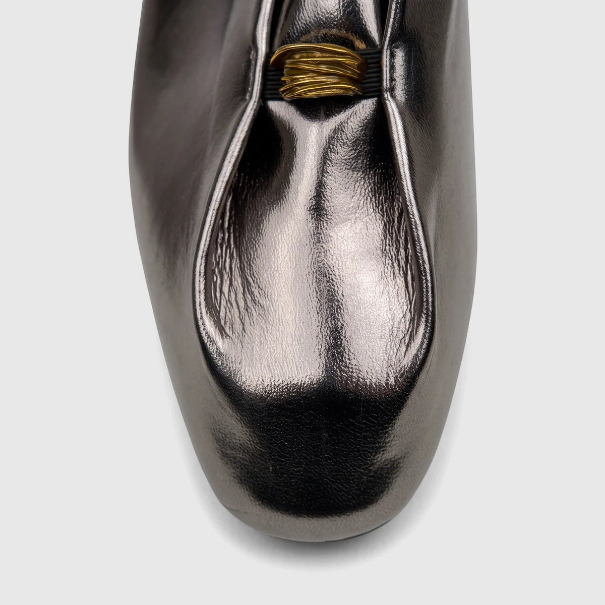 Close-up of a Bulbul Ladies Evening Pump in gunmetal metallic finish, featuring a gathered design and gold ring