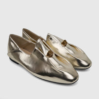 A pair of Bulbul Ladies Evening Pumps in light gold metallic finish, featuring a coiled decorative accent on the vamp,
