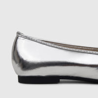 Side view of a Bulbul ladies' evening pump in shimmering silver metallic, featuring a sleek design and a contrasting black