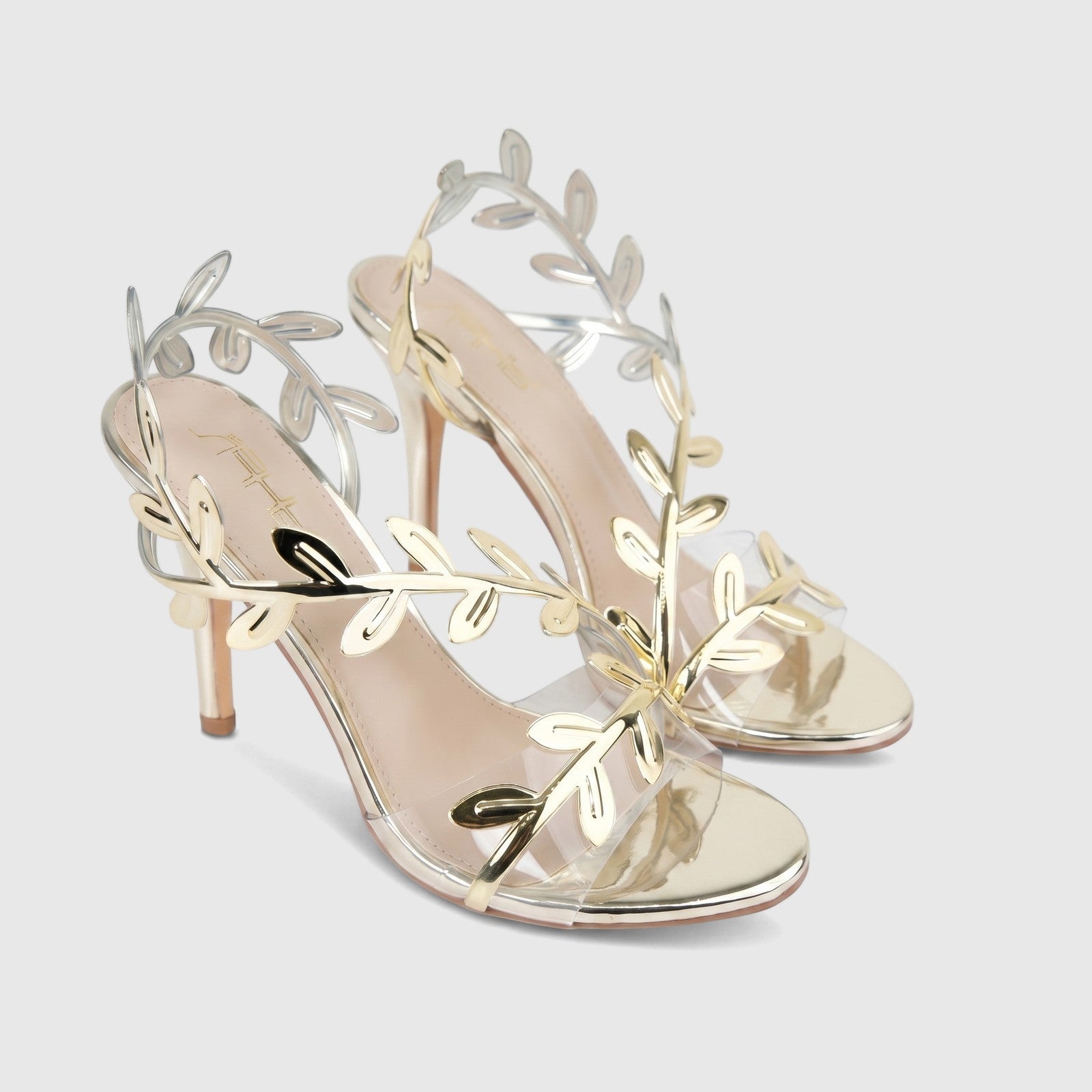 Bulbul Ladies Evening Sandal Gold HAR095 with intricate gold leaf-like ankle straps, clear toe straps, and elegant stiletto