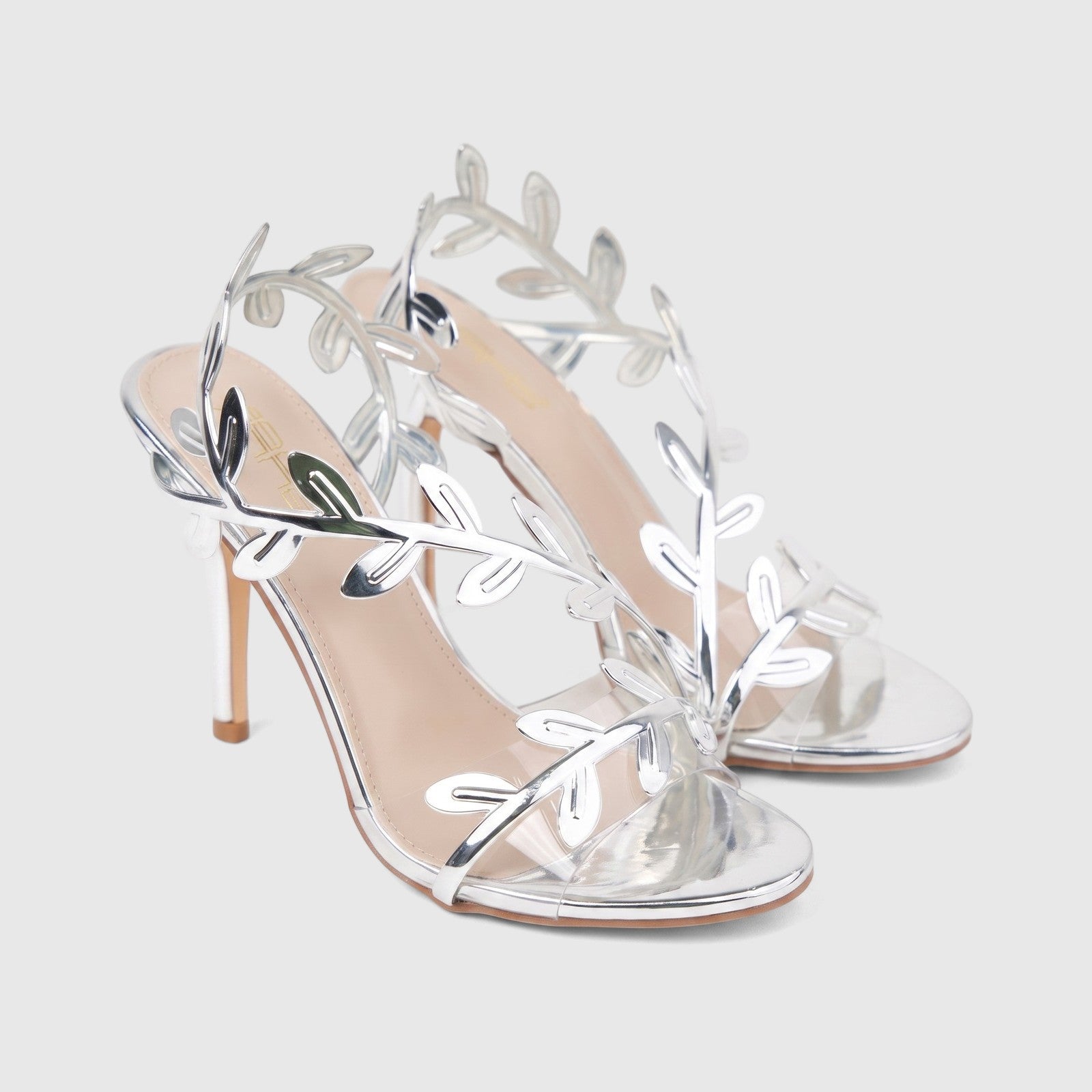 A pair of elegant Bulbul Ladies Evening Sandal HAR095 in silver, featuring delicate metallic leaf-shaped straps and a high