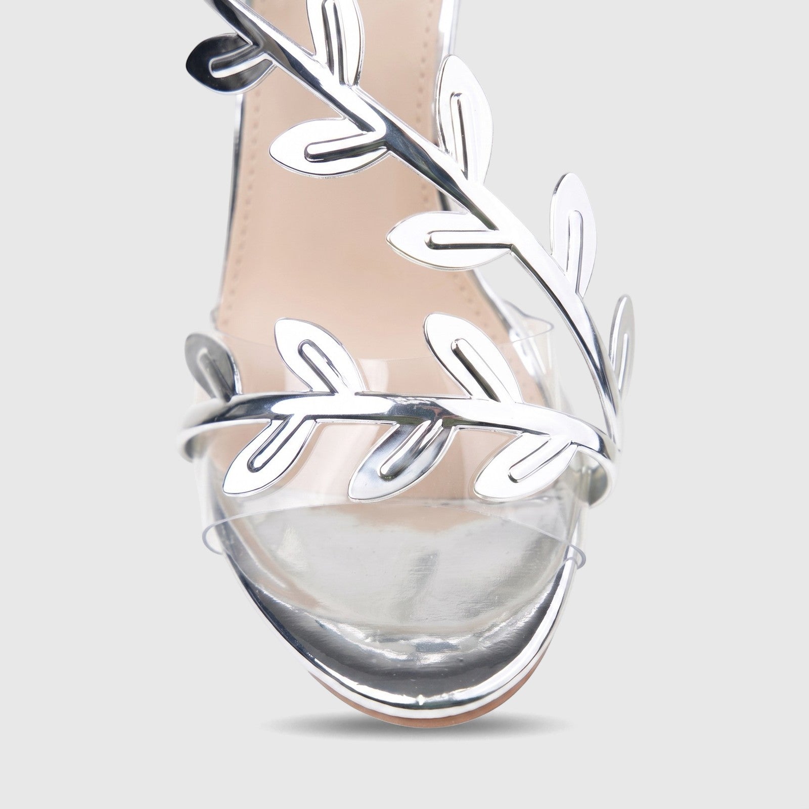 Bulbul Ladies Evening Sandal HAR095, featuring metallic silver leaf straps and a clear PVC toe strap, captured in a close-up