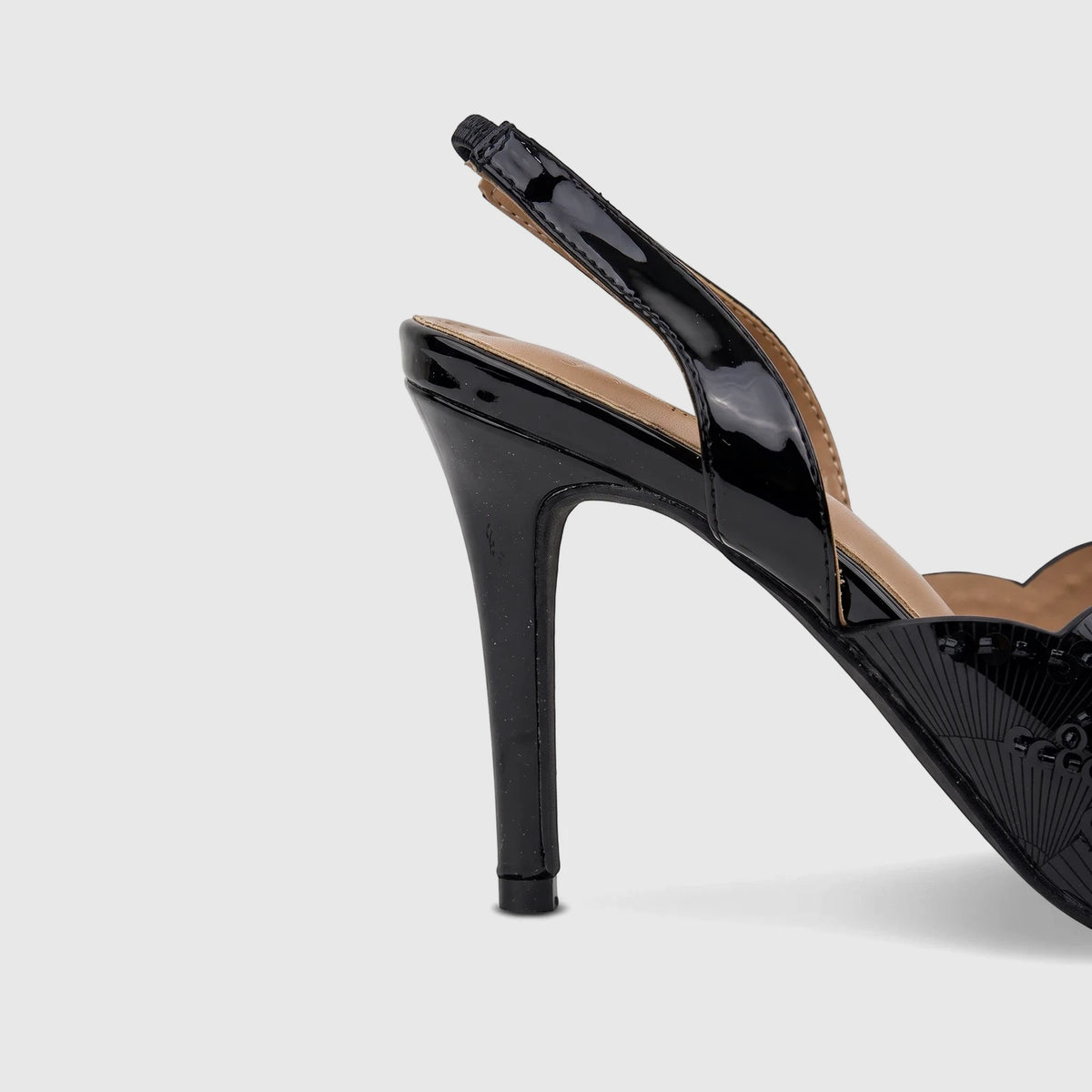 Close-up of a black patent leather slingback high-heeled sandal with sparkling sequin embellishments on the upper.