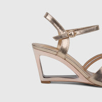 Champagne rose gold ladies evening slingback sandal with a unique clear wedge heel and ankle buckle strap.