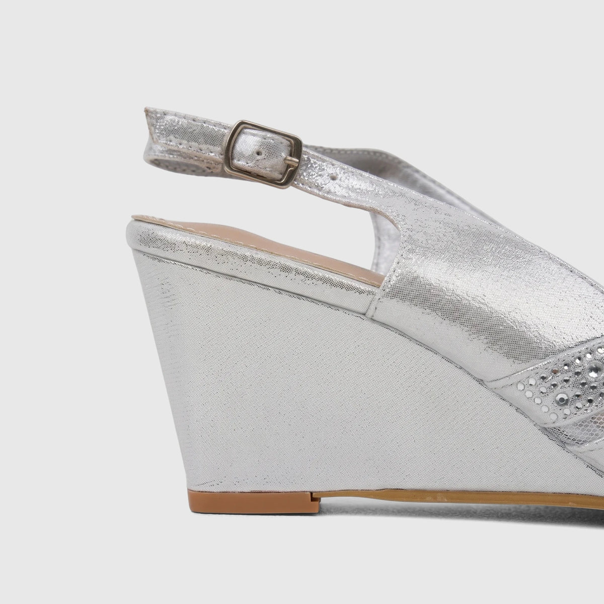 Close-up of a Bulbul Ladies Evening Wedge Sandal in silver, featuring a sparkly embellished front strap and a comfortable