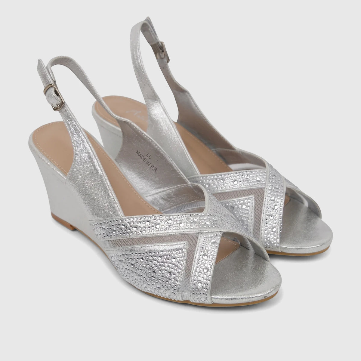 A pair of silver Bulbul Ladies Evening Wedge Sandals with rhinestone-embellished open-toe and slingback straps on a white
