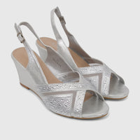 A pair of silver Bulbul Ladies Evening Wedge Sandals with rhinestone-embellished open-toe and slingback straps on a white