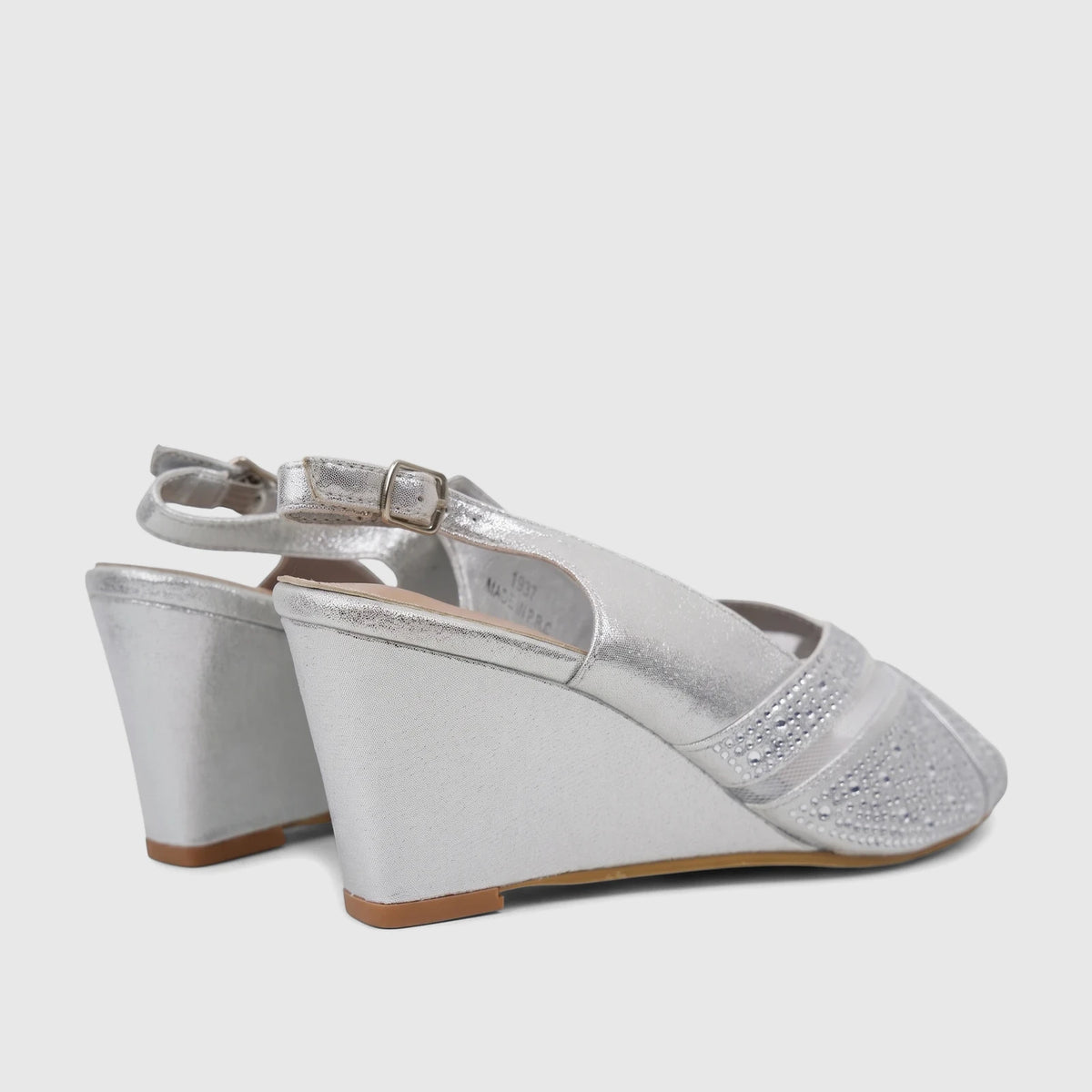 Pair of silver Bulbul Ladies Evening Wedge Sandals with sparkling rhinestone details and a wedge heel, shown from a