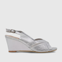 A silver ladies' evening wedge sandal with sparkling rhinestone-embellished straps and a comfortable wedge heel, side view.