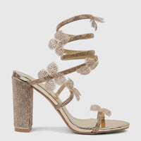 Bulbul Ladies gold spiral strap evening heel sandal with rhinestone embellishments and a chunky block heel, presented in a