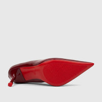 Bottom view of a shiny red patent leather high heel court shoe, showcasing its distinctive red sole with a textured pattern