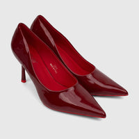 Pair of glossy red patent leather pointed-toe stiletto heels for ladies dress courts.