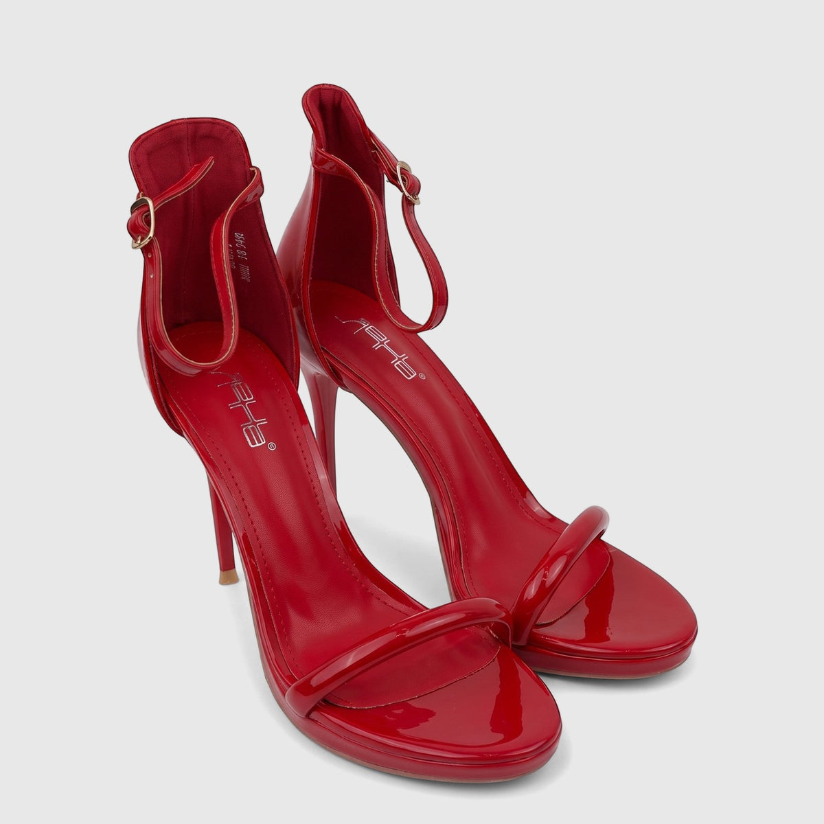 A pair of red patent leather Bulbul ladies stiletto heel sandals with ankle straps, high stiletto heels, and open toes.