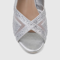 Close-up of a women's Bulbul silver evening wedge sandal with sparkling rhinestone criss-cross straps and a metallic finish.
