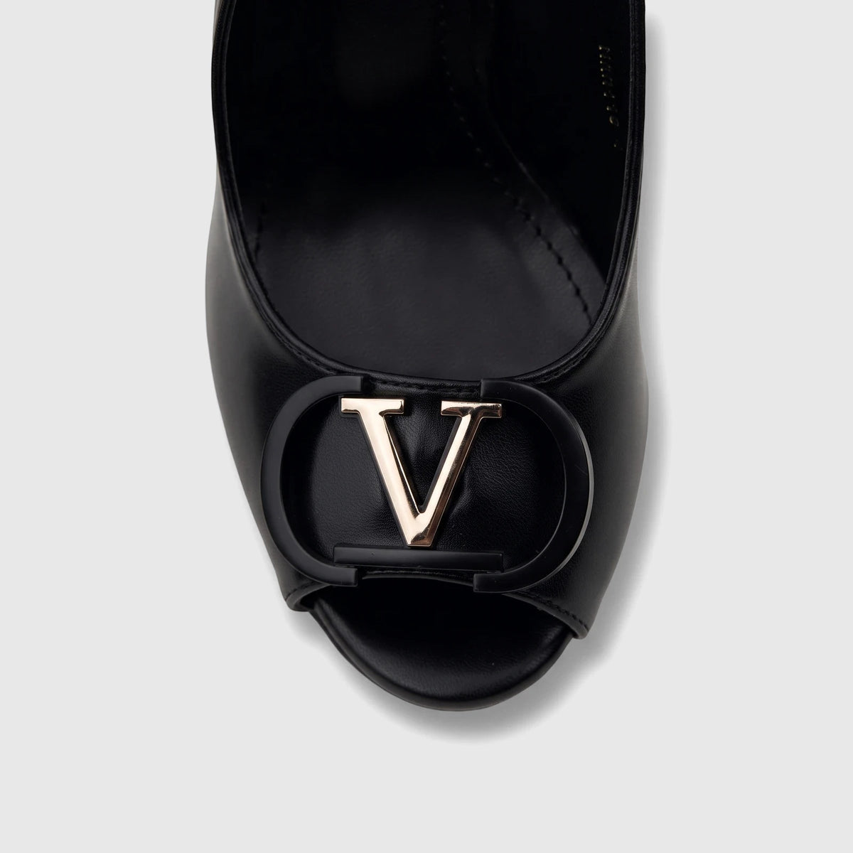 Close-up of a black Bulbul Ladies Slingback Peep Toe Sandal with a prominent gold-tone V logo on the front.