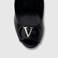 Close-up of a black Bulbul Ladies Slingback Peep Toe Sandal with a prominent gold-tone V logo on the front.