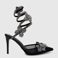 Bulbul Ladies Spiral Strap Evening Heel Sandal in black, featuring rhinestone flower embellishments and a pointed toe design.