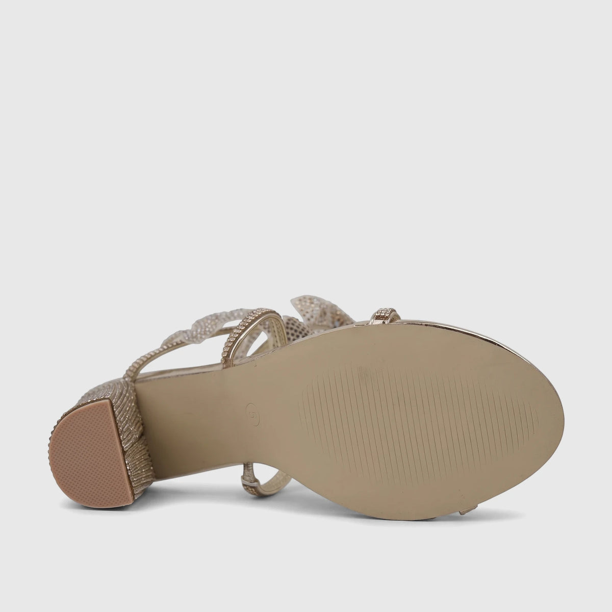 Gold Bulbul Ladies' evening heel sandal with spiral rhinestone straps and a block heel, viewed from the underside.