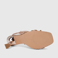 Rose gold Bulbul ladies' evening heel sandal with spiral straps, viewed from the bottom showing the textured sole and chunky