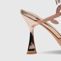 Close-up of a Bulbul Ladies Spiral Strap Evening Heel Sandal in rose gold, featuring a metallic flared heel and