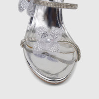 Silver Bulbul Ladies Spiral Strap Evening Heel Sandal, adorned with sparkling rhinestone details and a flower.