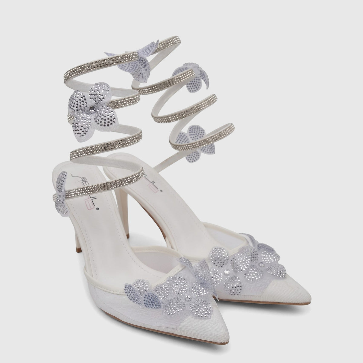 White Bulbul Ladies Spiral Strap Evening Heel Sandals with rhinestone-studded floral embellishments on a plain background.