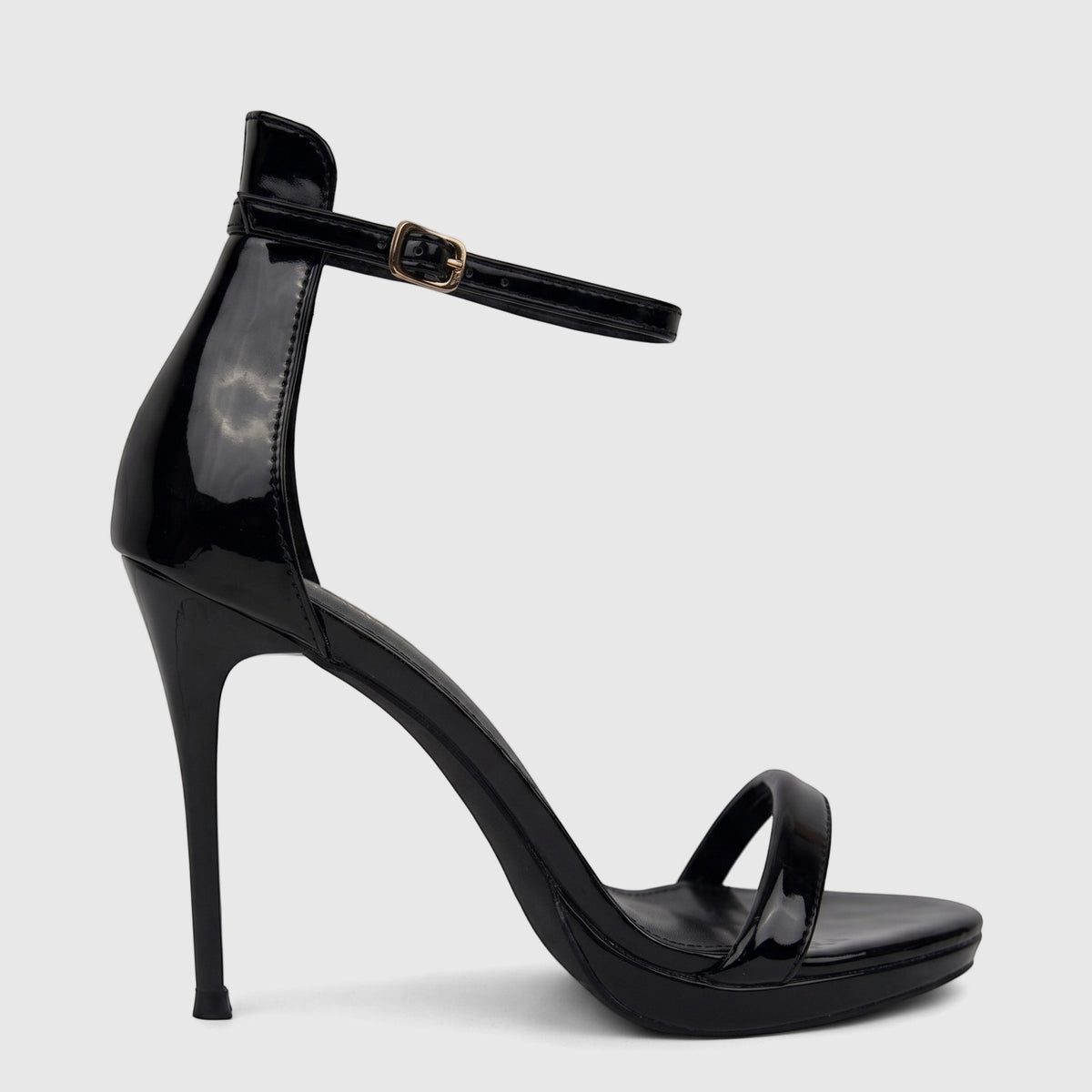 Black patent leather stiletto heel sandal with an ankle strap and gold buckle, shown in a close-up side view.