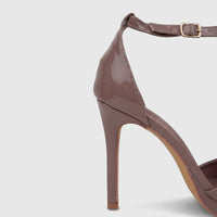 Mocha patent leather stiletto heel sandal for ladies, featuring an elegant ankle strap with a gold buckle.