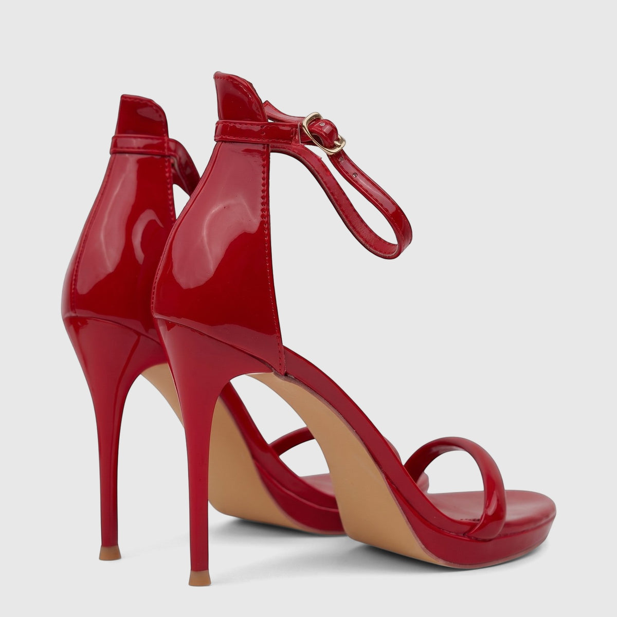 Pair of glossy red Bulbul ladies stiletto heel sandals with ankle straps, open-toe design, viewed from the back.