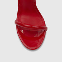 Close-up of a Bulbul Ladies Stiletto Heel Sandal in vibrant red patent leather, featuring an open-toe design and a rounded