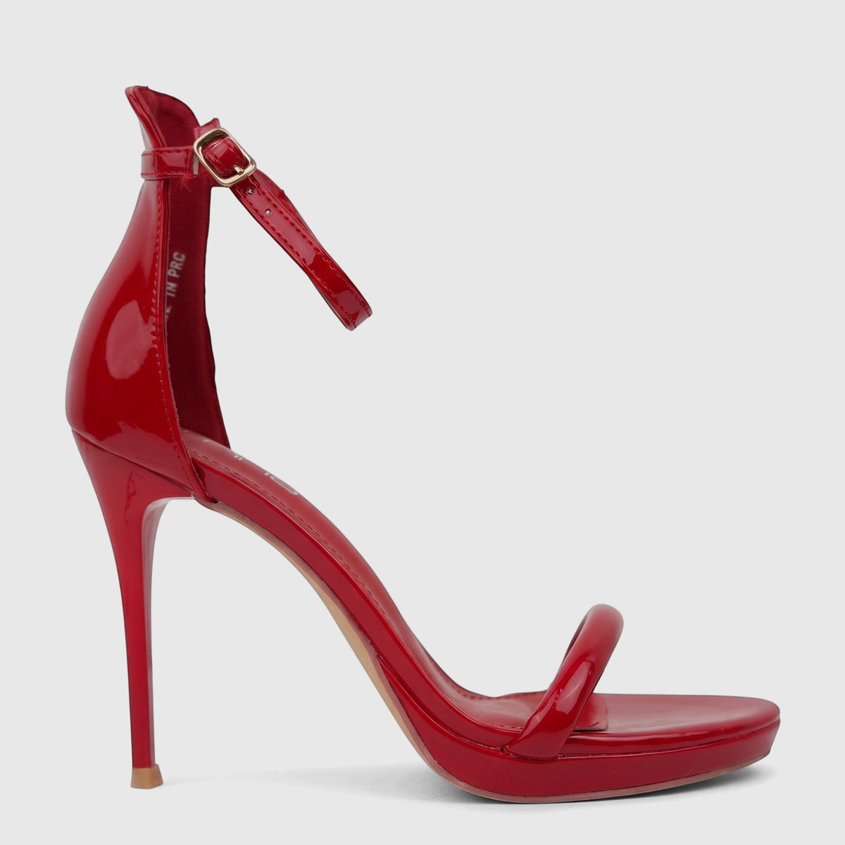 Vibrant red patent leather Bulbul Ladies Stiletto Heel Sandal with a high stiletto heel and a delicate ankle strap, shown in