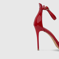 Bulbul Ladies Stiletto Heel Sandal in vibrant red patent leather with a high heel and ankle strap, shown from a side view.