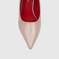 Close-up front view of a Bulbul nude patent leather pointed-toe dress court shoe with red interior lining.