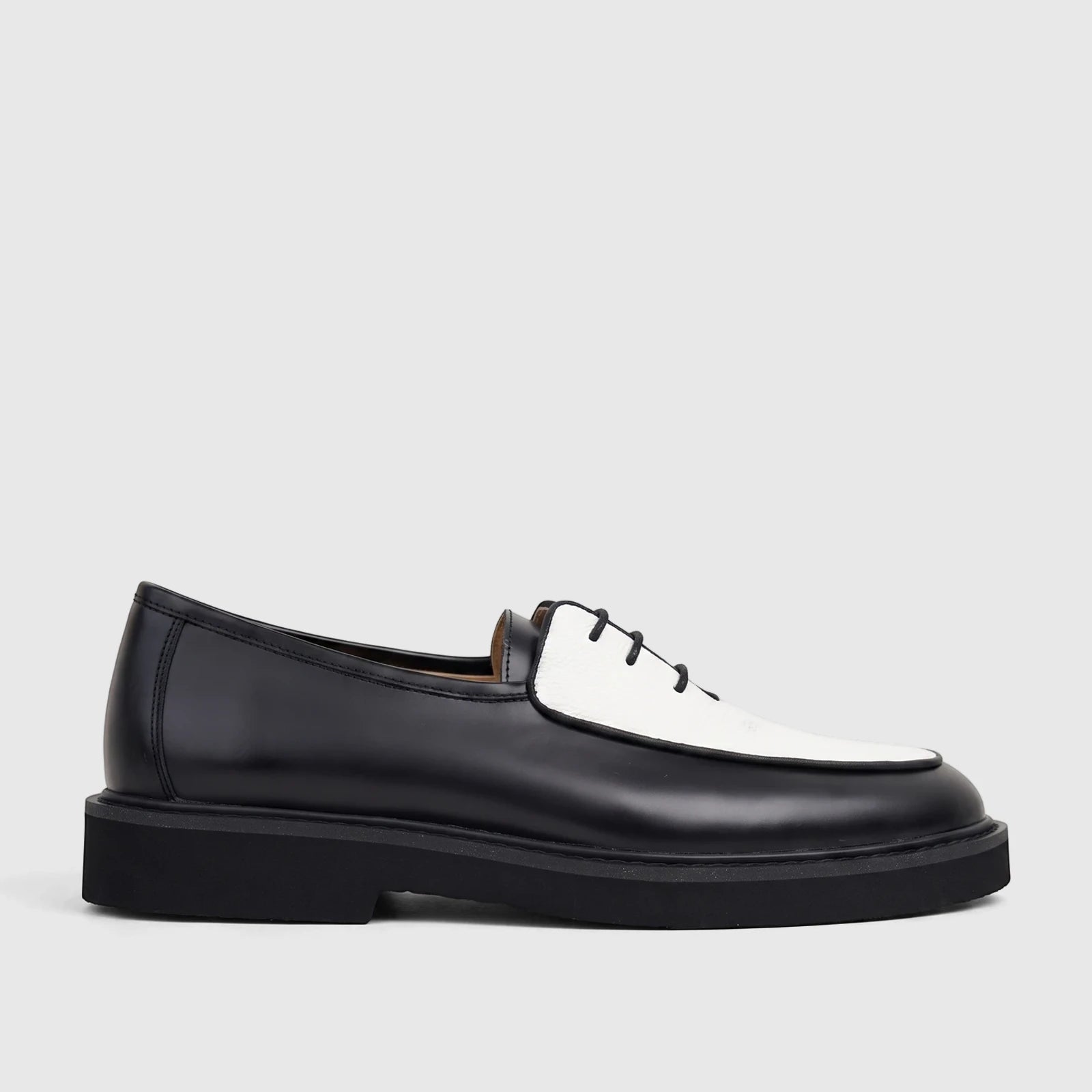 Bulletti Men's B7801M Odyssey lace-up shoe in black and white leather with a chunky sole, side view.