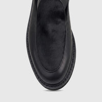 Black men's leather chunky sole sandal with a fur panel, featuring prominent sole stitching, viewed from above.