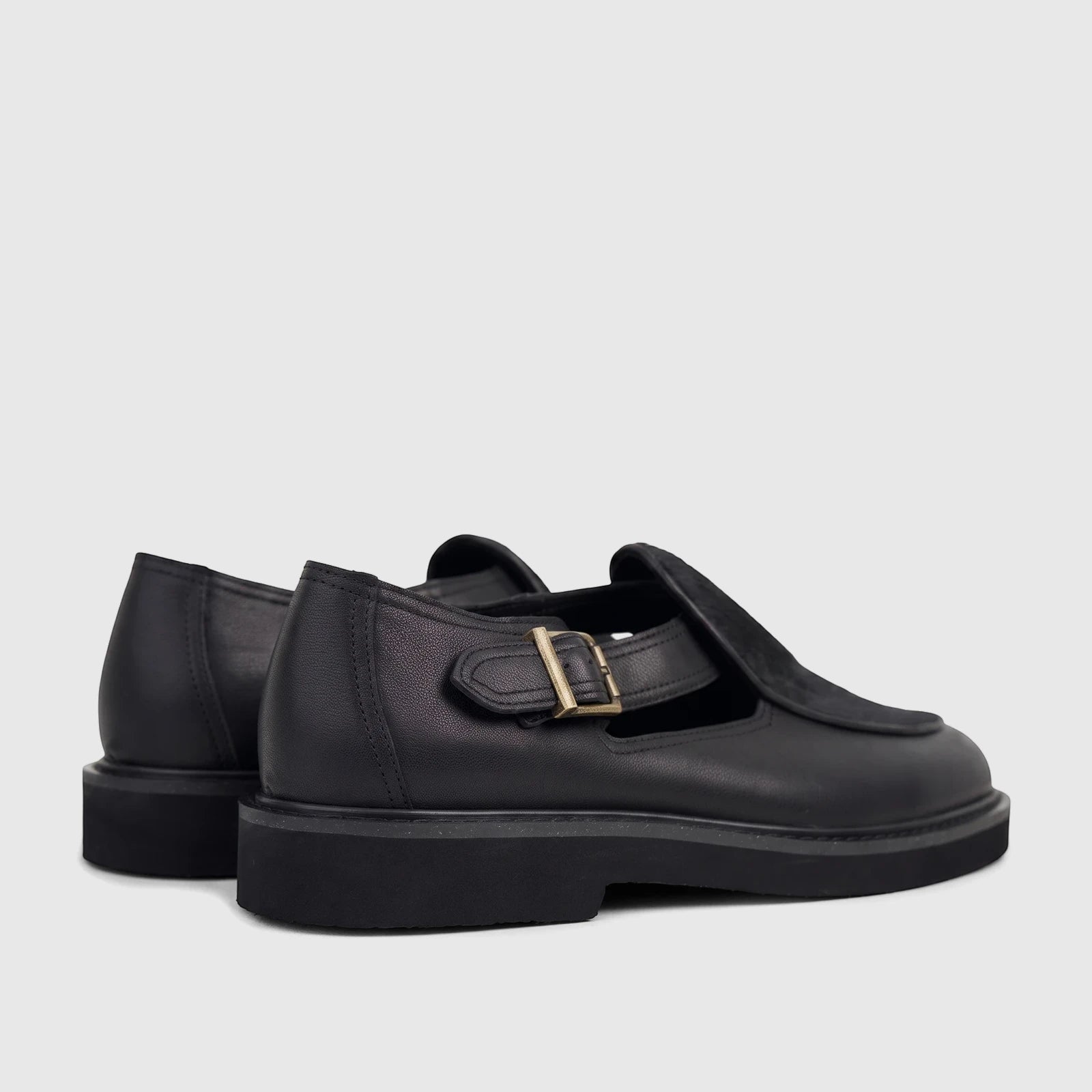 Bulletti Men's black leather chunky sole sandals with a buckle closure, captured from a side-back view.