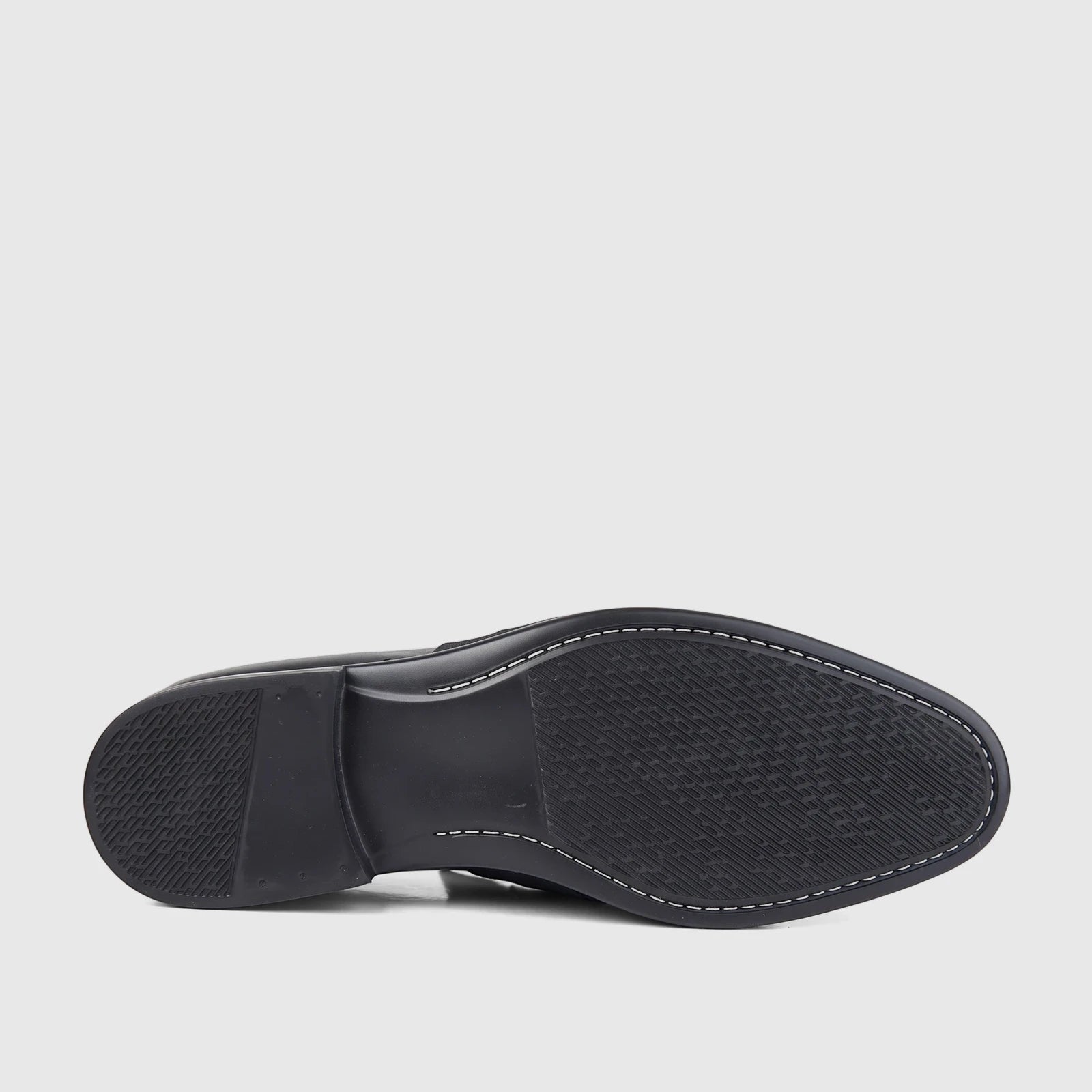 Bottom view of a Bulletti men's black leather dress slip-on shoe, showcasing the textured rubber sole with white stitching.