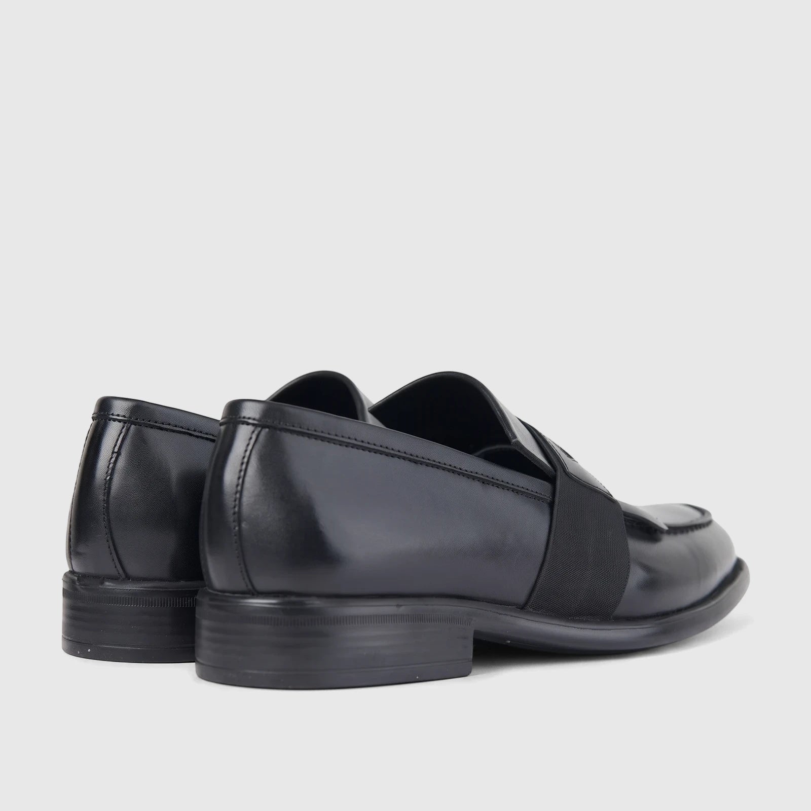 Bulletti men's black leather slip-on dress shoes, featuring an elastic strap across the vamp, presented from a rear-side