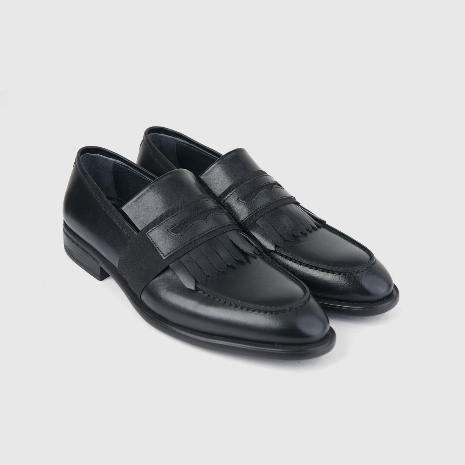 Bulletti mens black leather dress slip-on loafers with fringe detail, pair shown in angled side view.